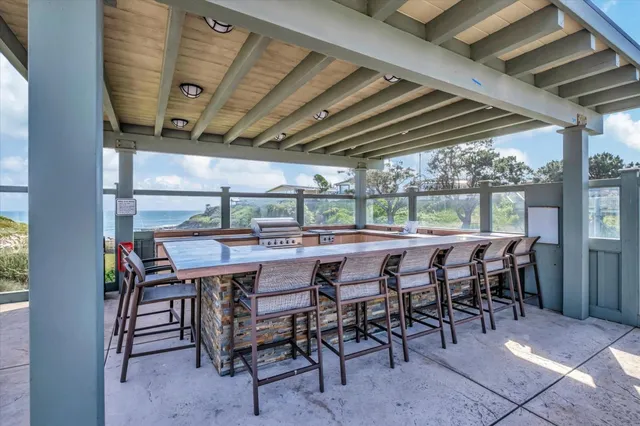 a view of a patio with a table chairs and backyard