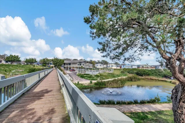 a view of a lake with houses in back