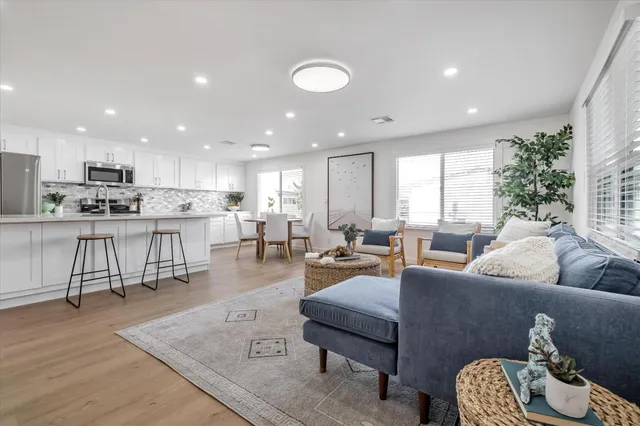 a living room with furniture and kitchen view