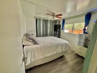 a bedroom with a bed and a mirror