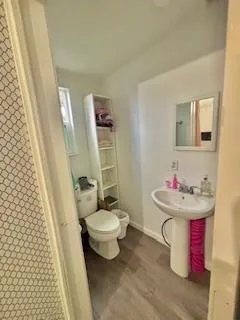 a bathroom with a sink toilet and a mirror