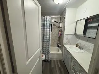 a bathroom with a sink a mirror and shower
