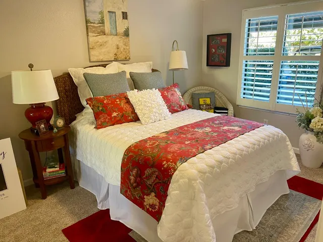 a bedroom with bed and window