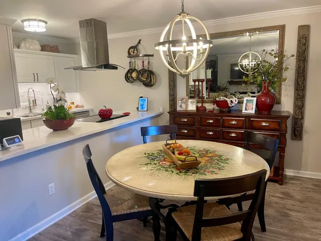 a kitchen with a dining table and chairs