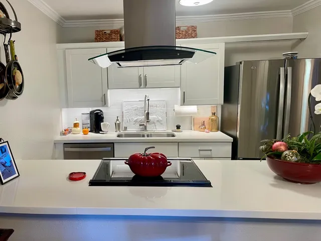 a kitchen with a refrigerator and a more cabinets