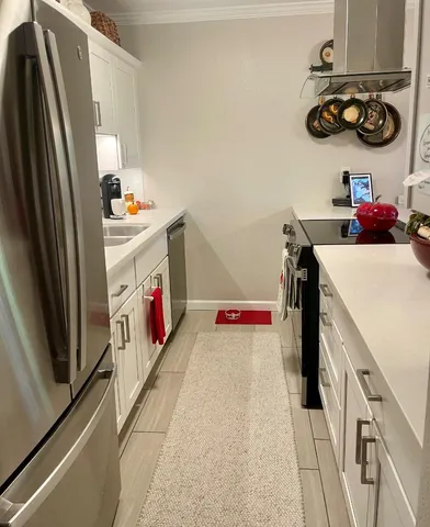 a kitchen with stainless steel appliances granite countertop a sink and refrigerator