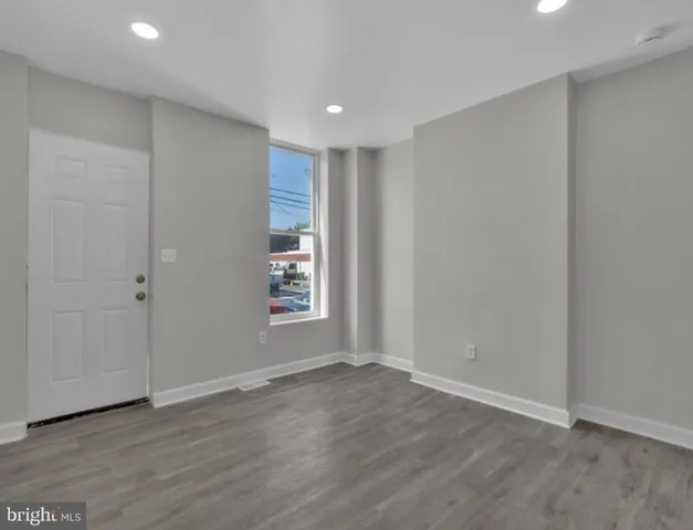 a view of wooden floor and windows in a room