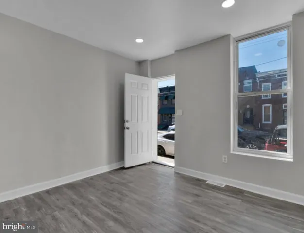 a view of wooden floor and windows in a room