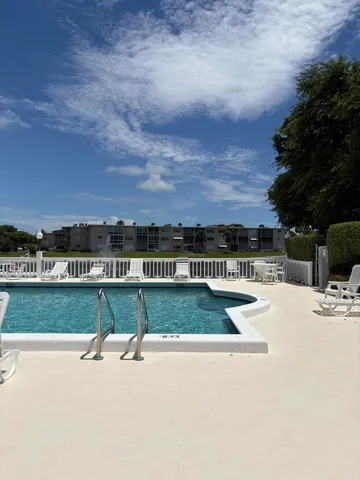 a view of a patio with table and chairs potted plants