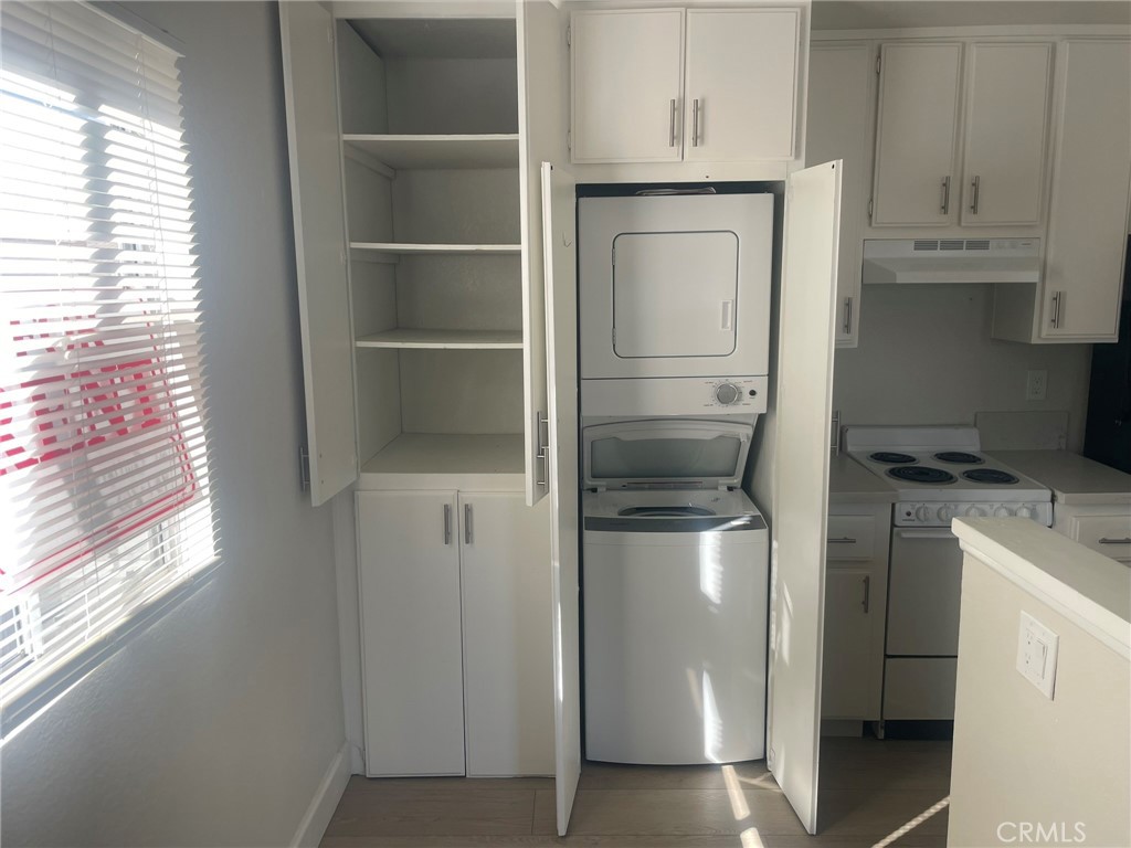 3703 Country Oaks Loop, Unit B Ontario, CA 91761 - Photo 19 of 30 a kitchen with a refrigerator and cabinets