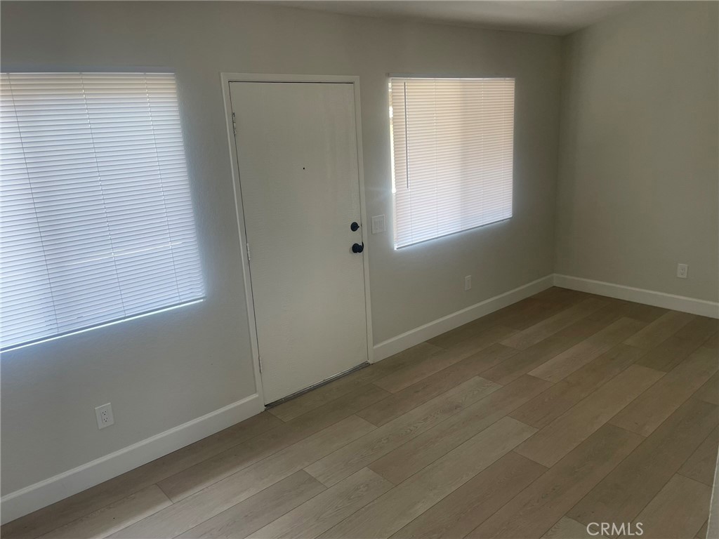 3703 Country Oaks Loop, Unit B Ontario, CA 91761 - Photo 9 of 30 an empty room with a window