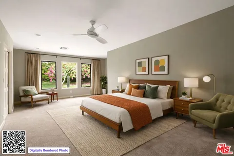 a large bedroom with a large bed couch and a window