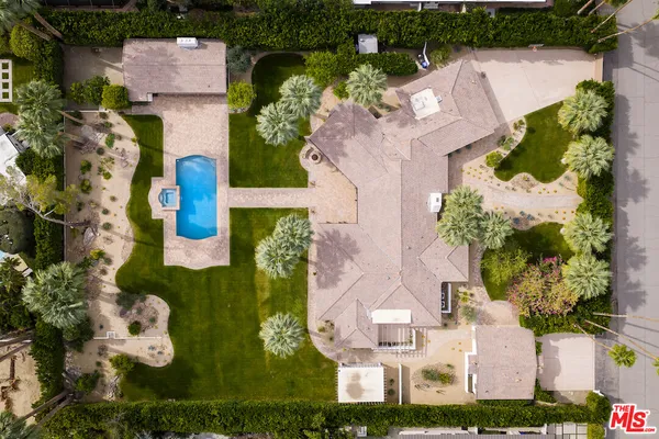 an aerial view of a house with a garden and plants