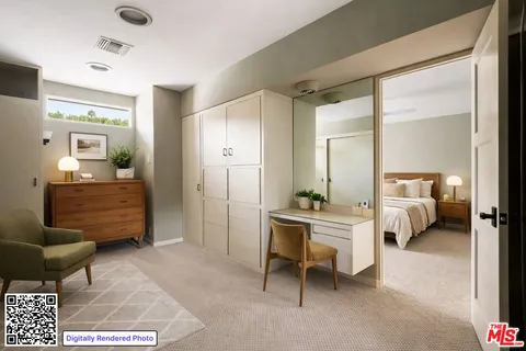 a bedroom with furniture and a large mirror