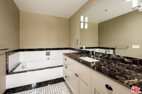 a bathroom with a bathtub and a sink