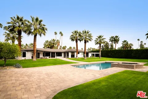 a house with swimming pool in front of it