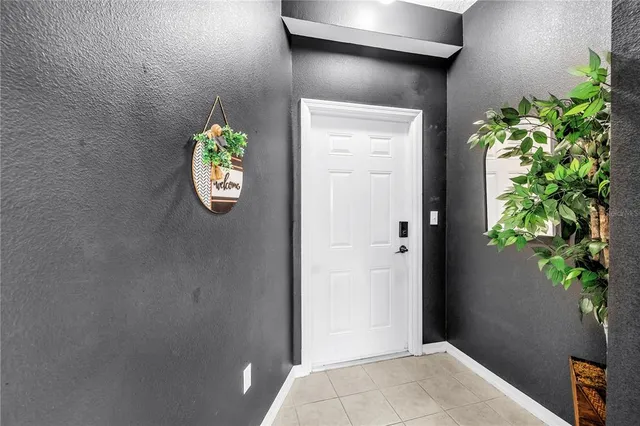 a kitchen with granite countertop a refrigerator and a stove top oven
