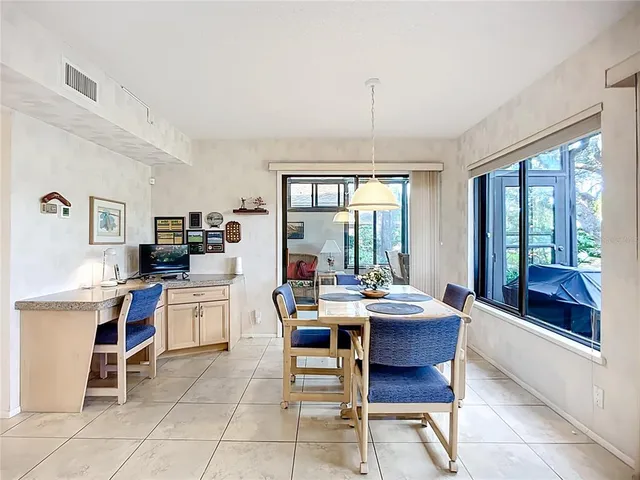 a dining room with furniture and window