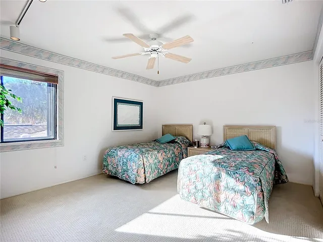 a bedroom with two beds and painting on the wall