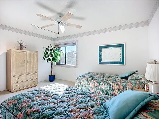 a bedroom with a bed chandelier and a window
