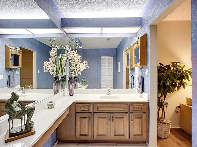 a bathroom with a sink a large mirror and a shower