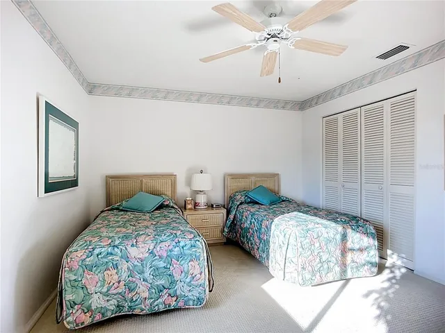 a bedroom with two beds and a chandelier