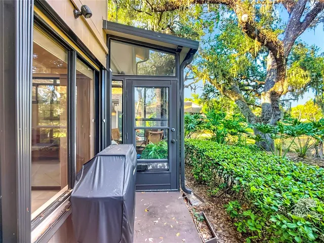 a view of a porch with furniture and garden