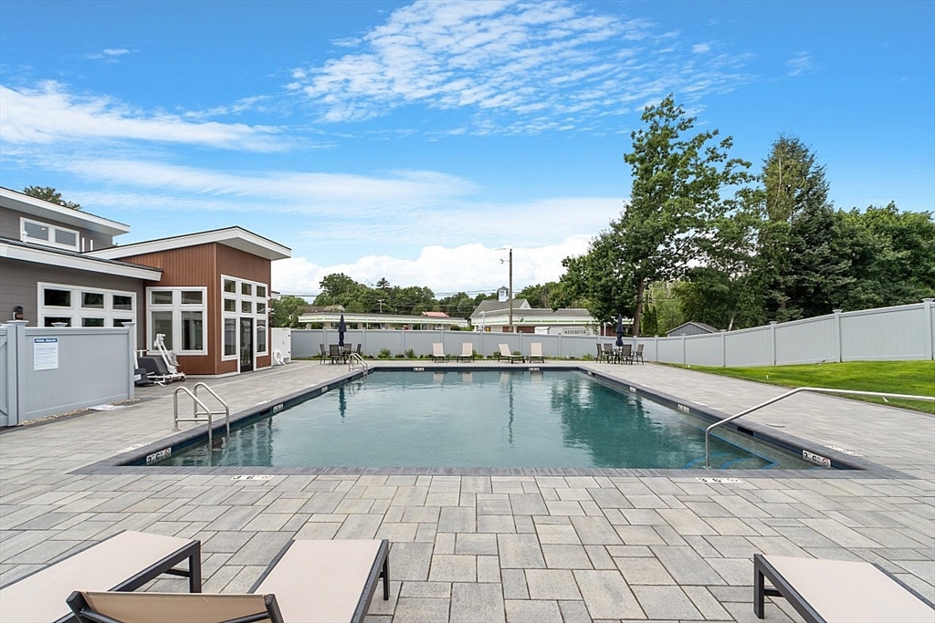 36 Vantage Point Drive, Unit 4 Laconia, NH 03246 - Photo 38 of 42 a view of a swimming pool with a lounge chair