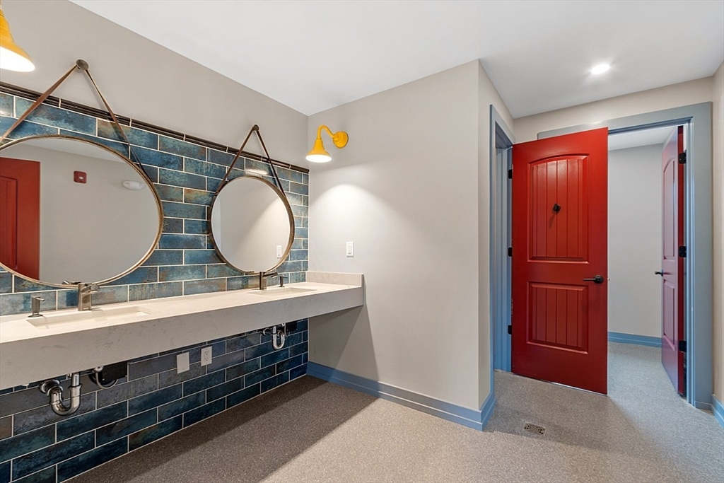 36 Vantage Point Drive, Unit 4 Laconia, NH 03246 - Photo 41 of 42 a bathroom with a double vanity sink mirror and