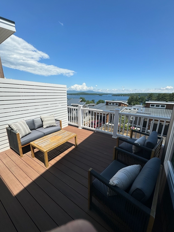 36 Vantage Point Drive, Unit 4 Laconia, NH 03246 - Photo 5 of 42 a roof deck with a table and chairs