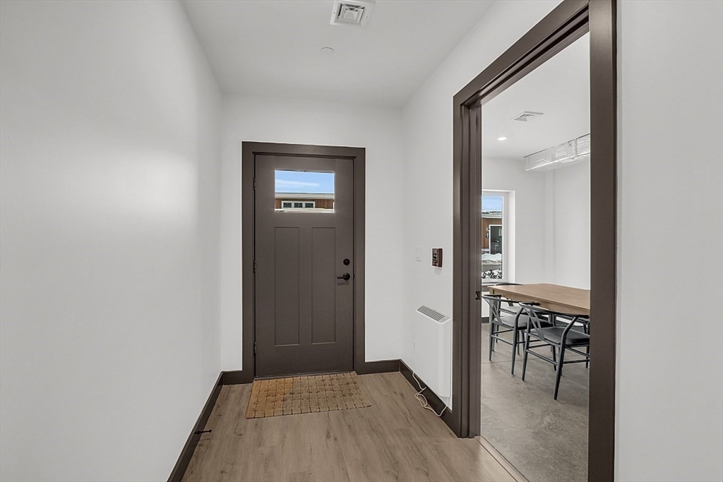 36 Vantage Point Drive, Unit 4 Laconia, NH 03246 - Photo 10 of 42 a view of a hallway with wooden floor and a dining room