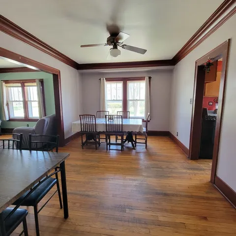 a view of a dining room with furniture and wooden floor