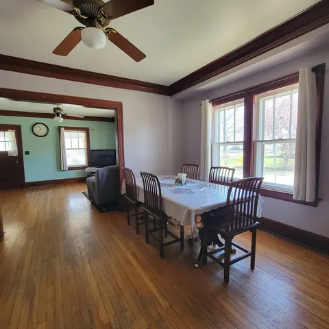a view of a livingroom with furniture window and wooden floor