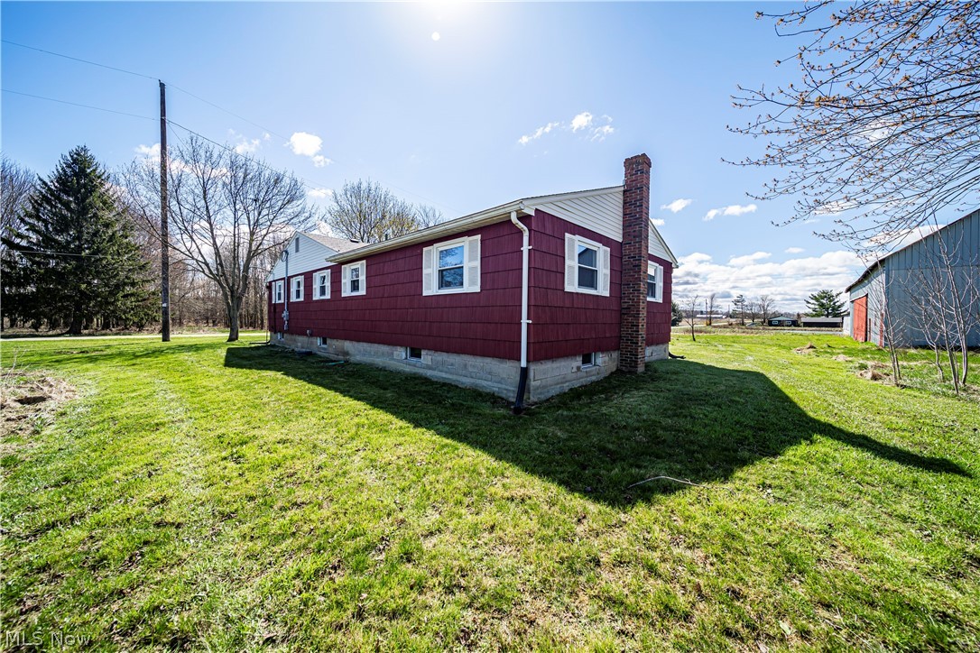 3395 Maple Road Jefferson, OH 44047 - Photo 13 of 36 View of property exterior featuring a lawn