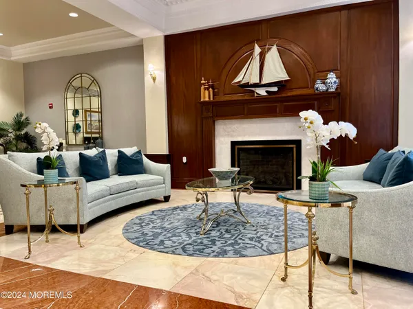 a living room with furniture a fireplace and a table
