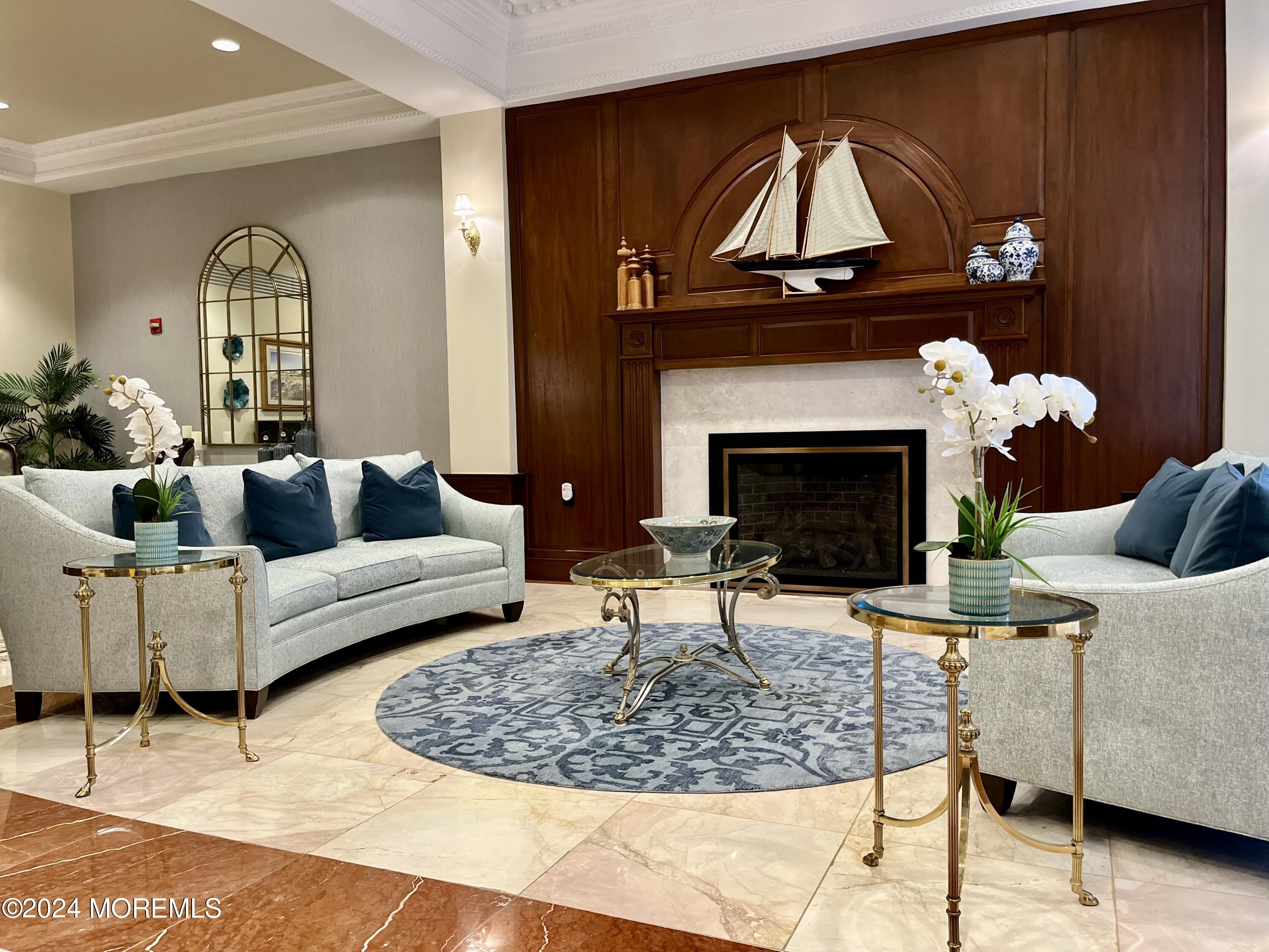 a living room with furniture a fireplace and a table