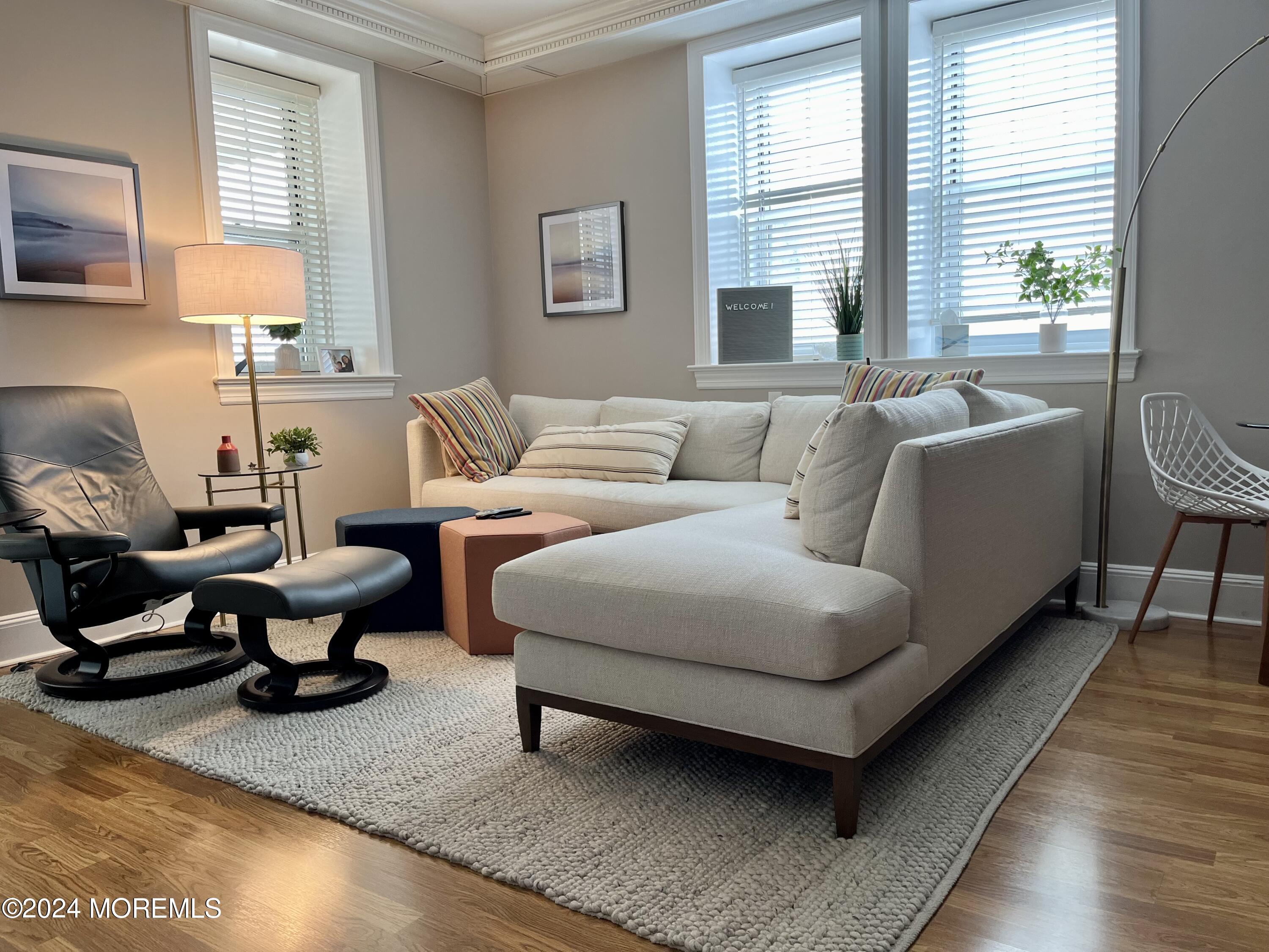 700 Ocean Avenue, Unit G38 Spring Lake, NJ 07762 - Photo 1 of 37 a living room with furniture and a large window