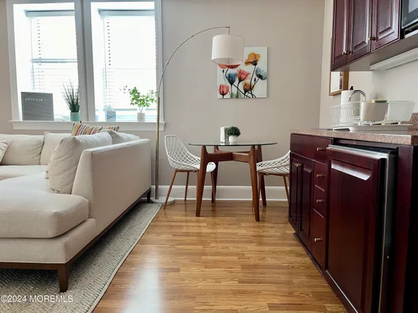 a living room with furniture and a wooden floor