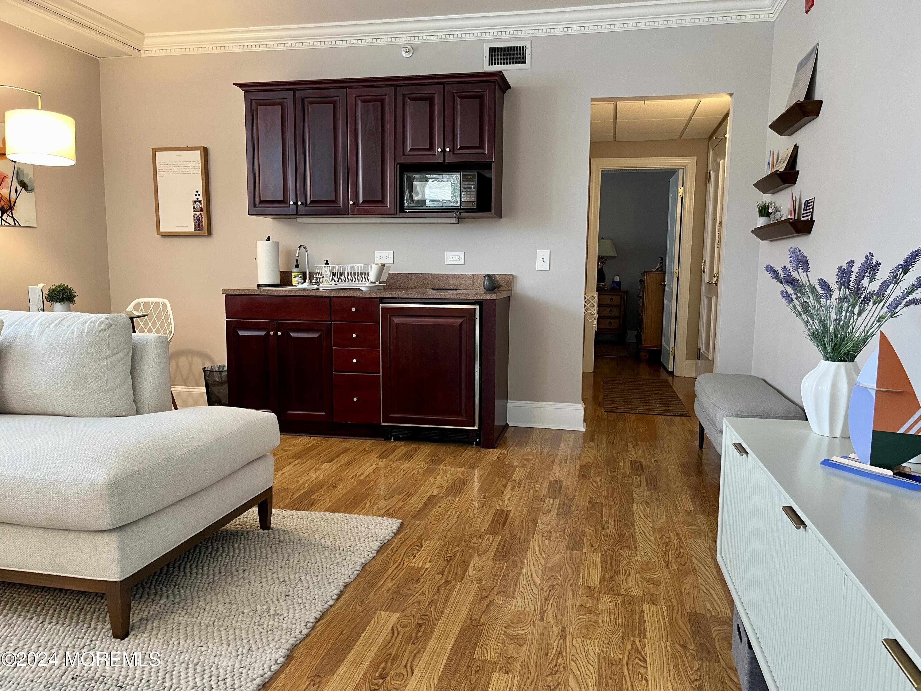 700 Ocean Avenue, Unit G38 Spring Lake, NJ 07762 - Photo 13 of 37 a living room with furniture and a flat screen tv