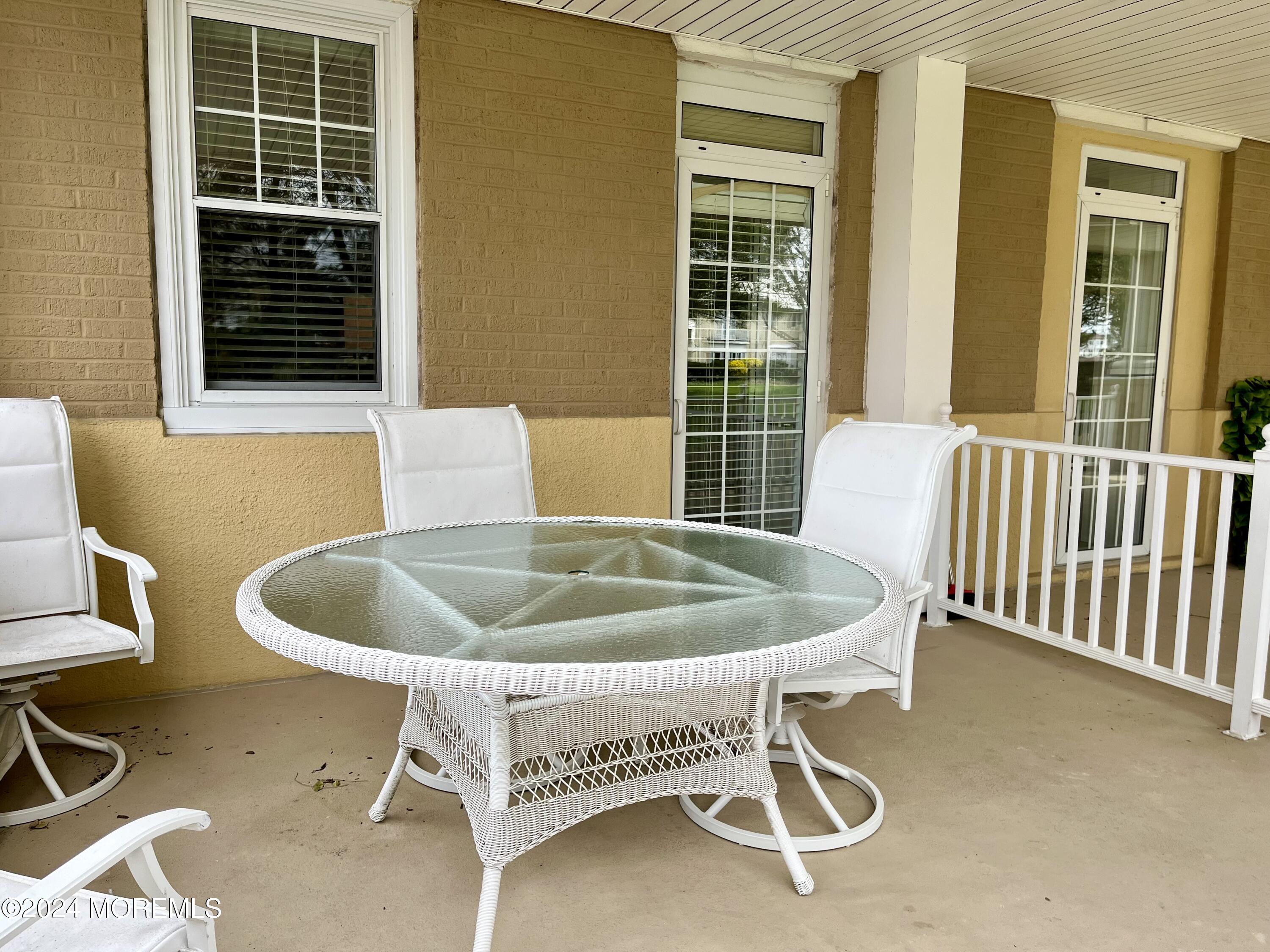 700 Ocean Avenue, Unit G38 Spring Lake, NJ 07762 - Photo 17 of 37 a bed and table in front of a house