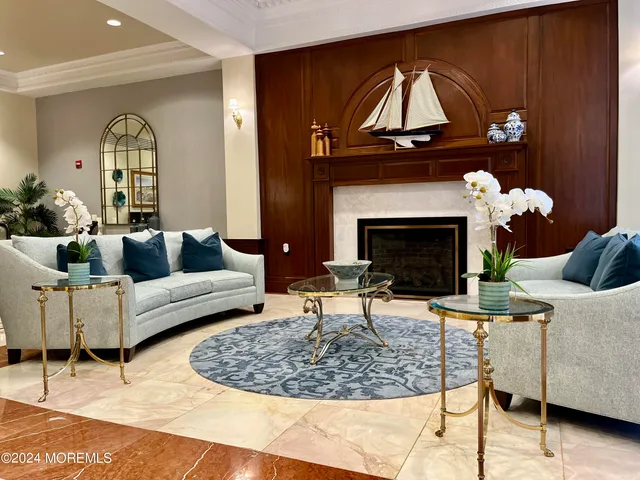 a living room with furniture a fireplace and a table