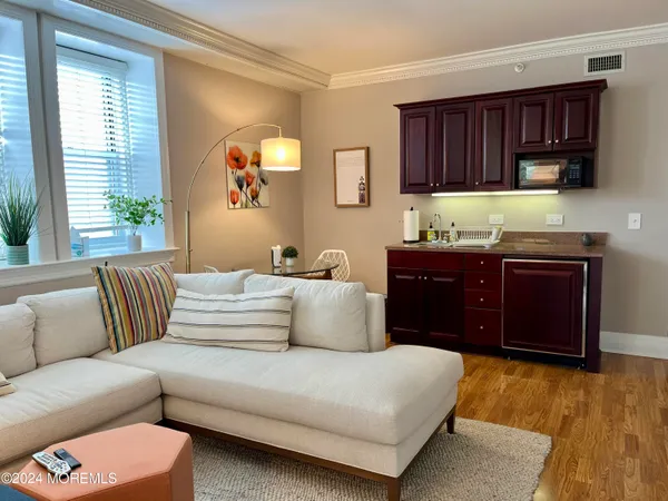 a living room with a couch and a dresser