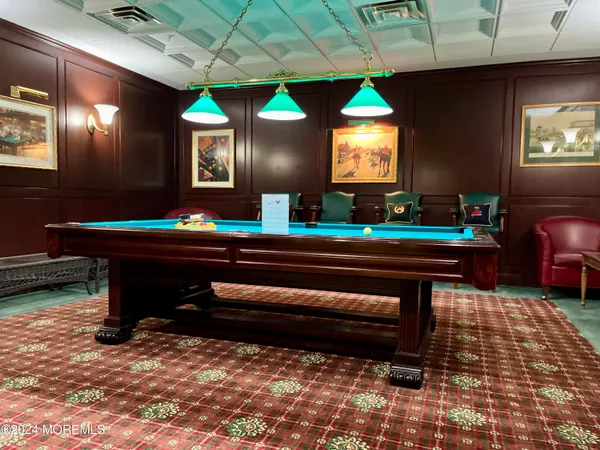 a room with pool table table soccer and windows