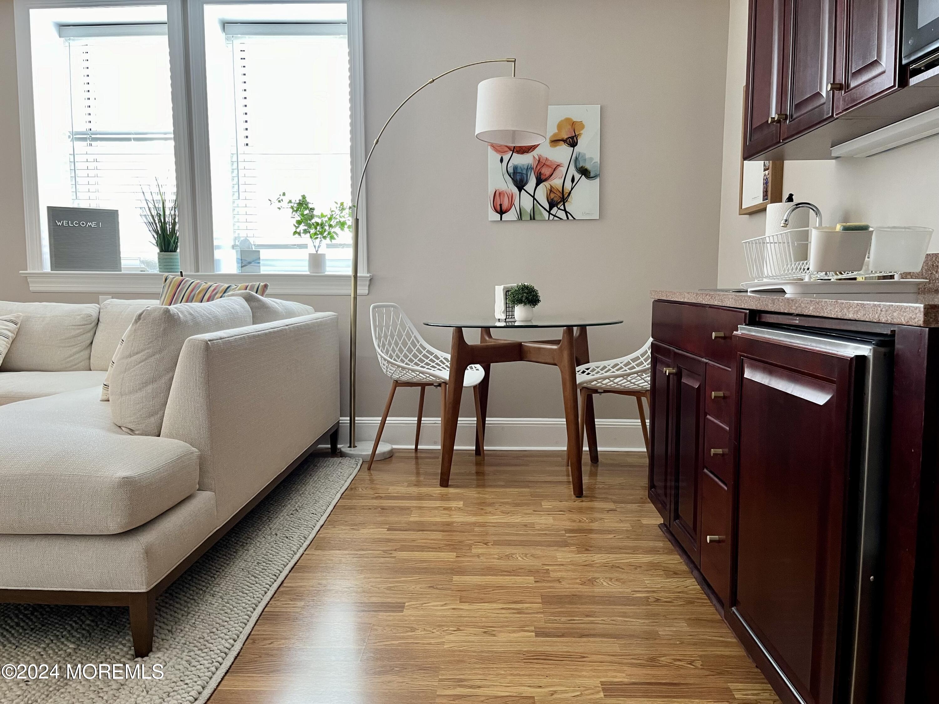700 Ocean Avenue, Unit G38 Spring Lake, NJ 07762 - Photo 2 of 37 a living room with furniture and a wooden floor