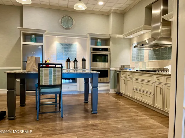 a kitchen with cabinets and chairs
