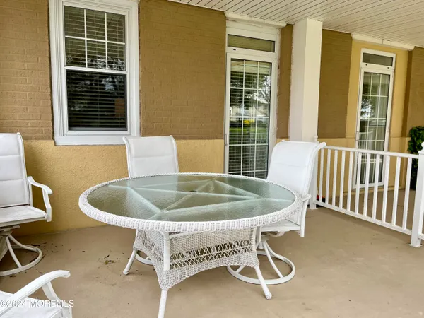a bed and table in front of a house