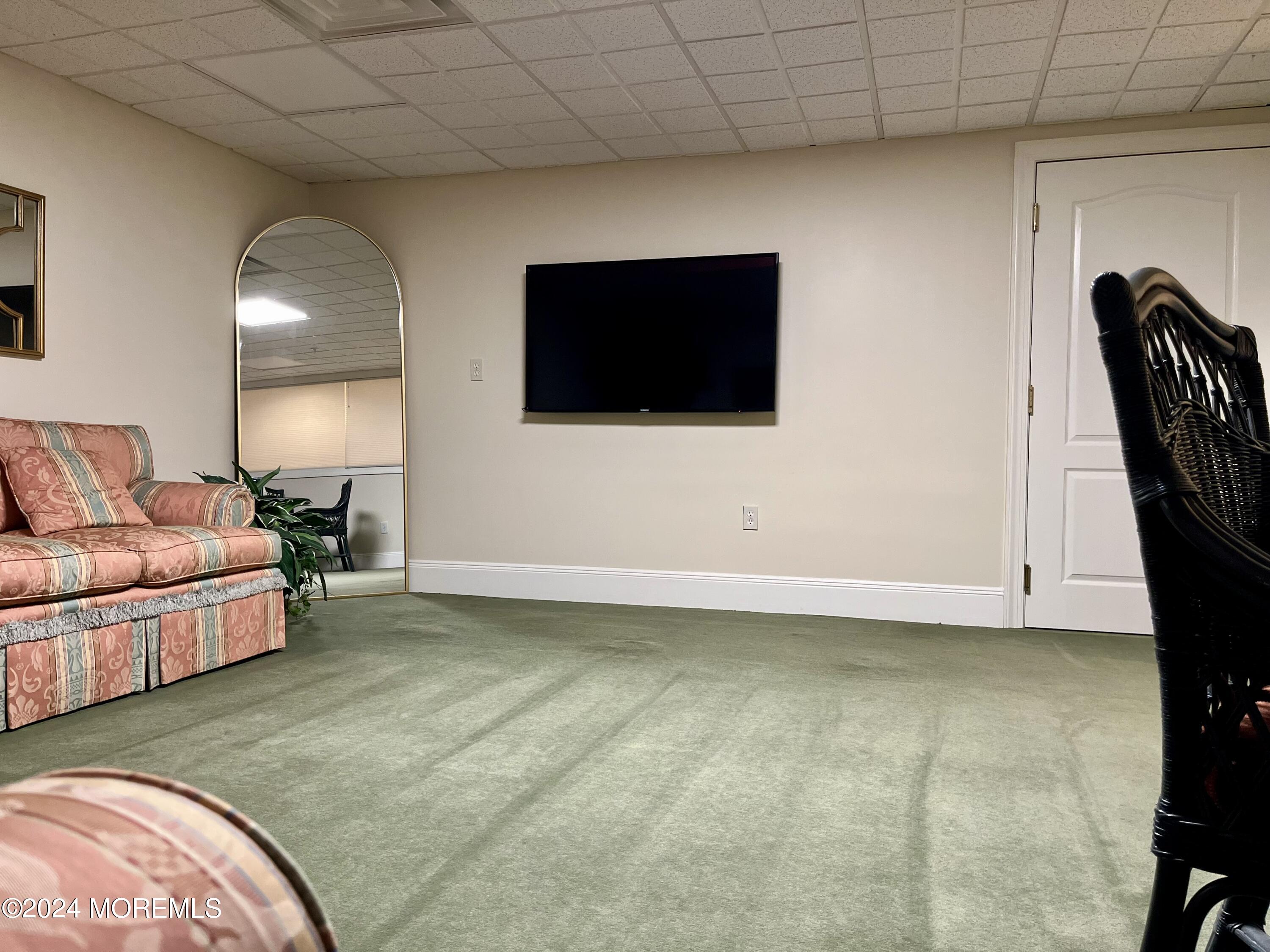 700 Ocean Avenue, Unit G38 Spring Lake, NJ 07762 - Photo 28 of 37 a living room with furniture and a flat screen tv
