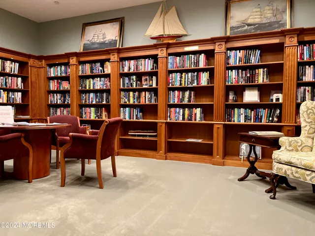 a living room with furniture a chandelier and a dining table