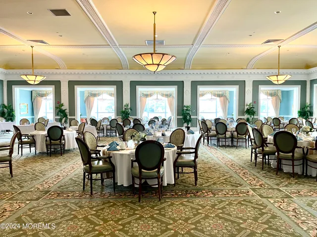 a living room with furniture a chandelier and a fireplace