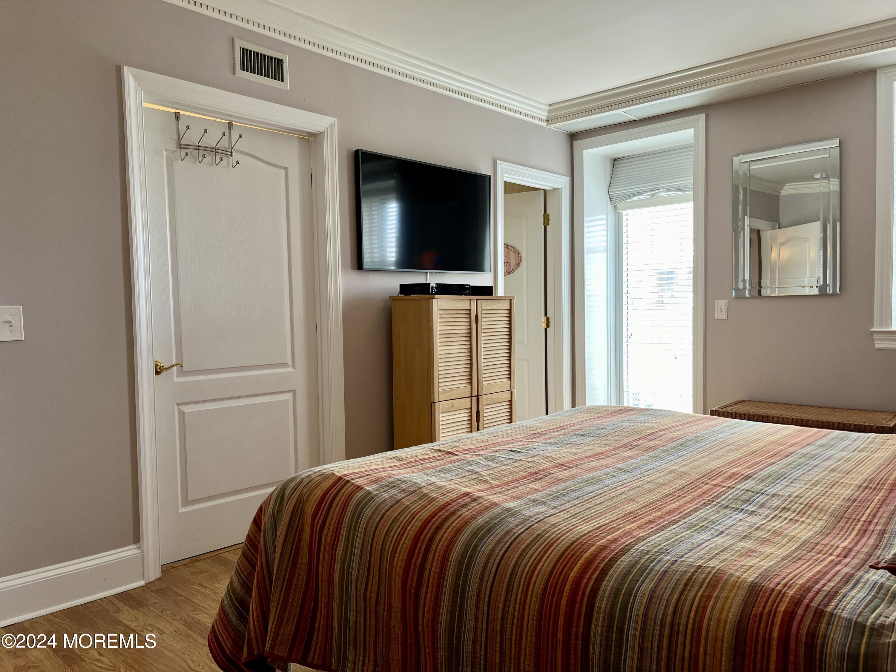 700 Ocean Avenue, Unit G38 Spring Lake, NJ 07762 - Photo 6 of 37 a bedroom with a bed and a flat screen tv
